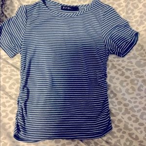 This T-shirt is tight on On the sides and has blue and white stripes.